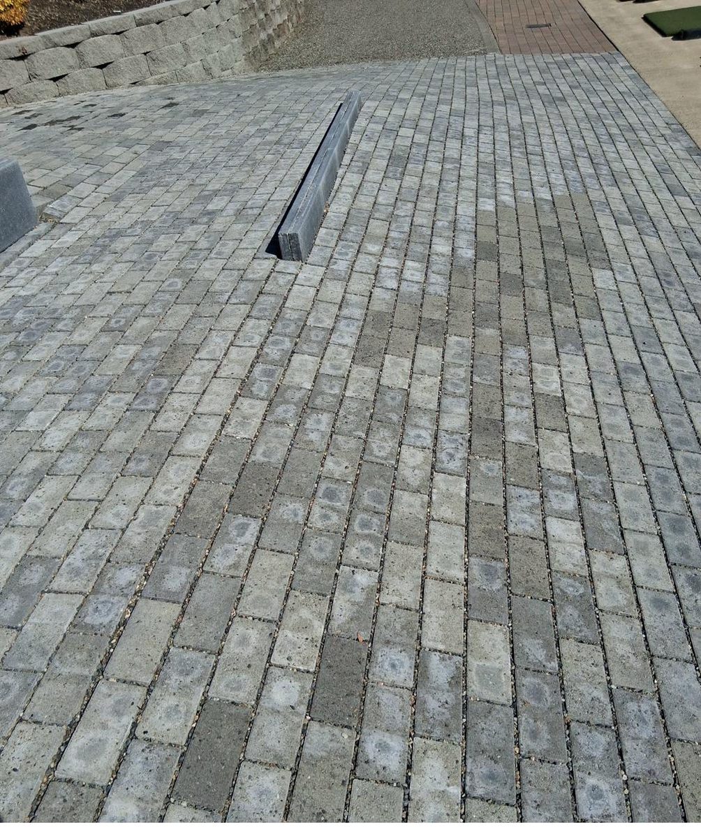 Gray paver driveway with concrete curbing