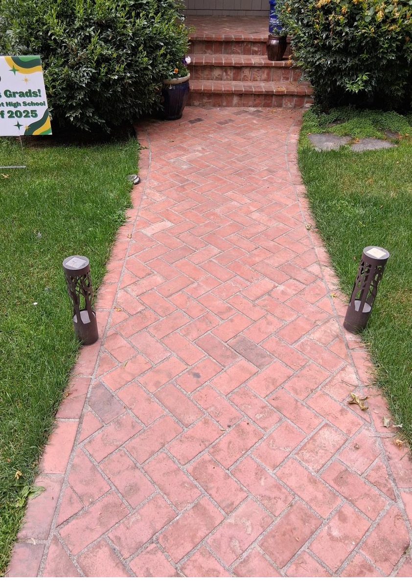 Red brick herringbone walkway with path lighting