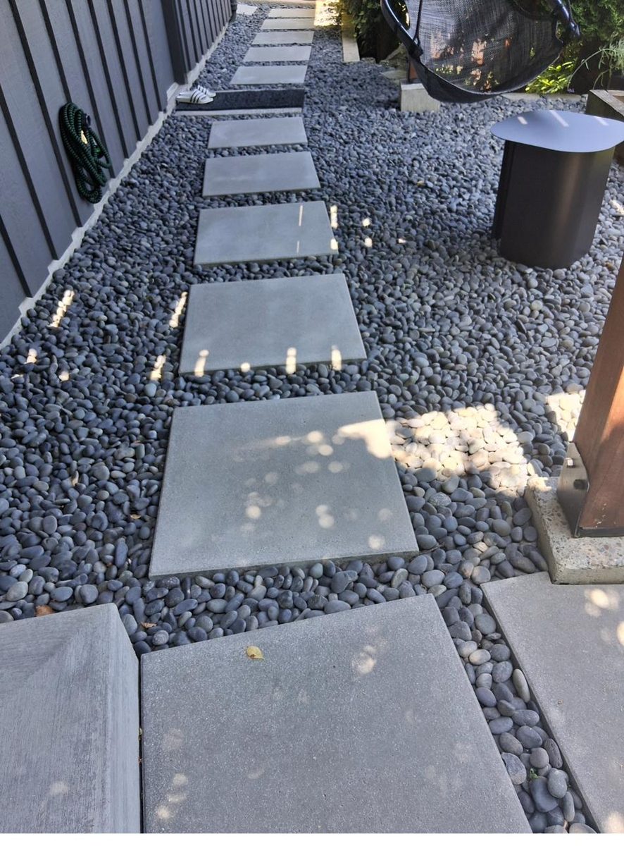 Modern stepping stones in dark river rock